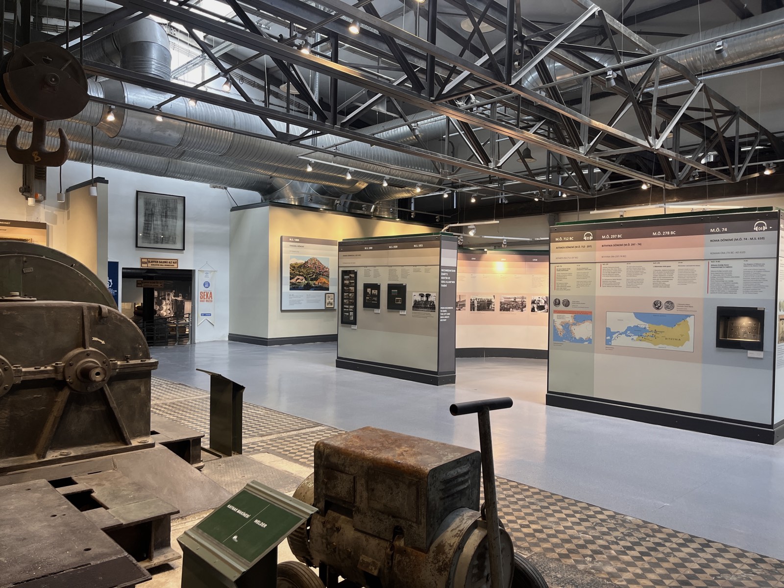 Industrial heritage museum exhibition with historical machinery and a timeline