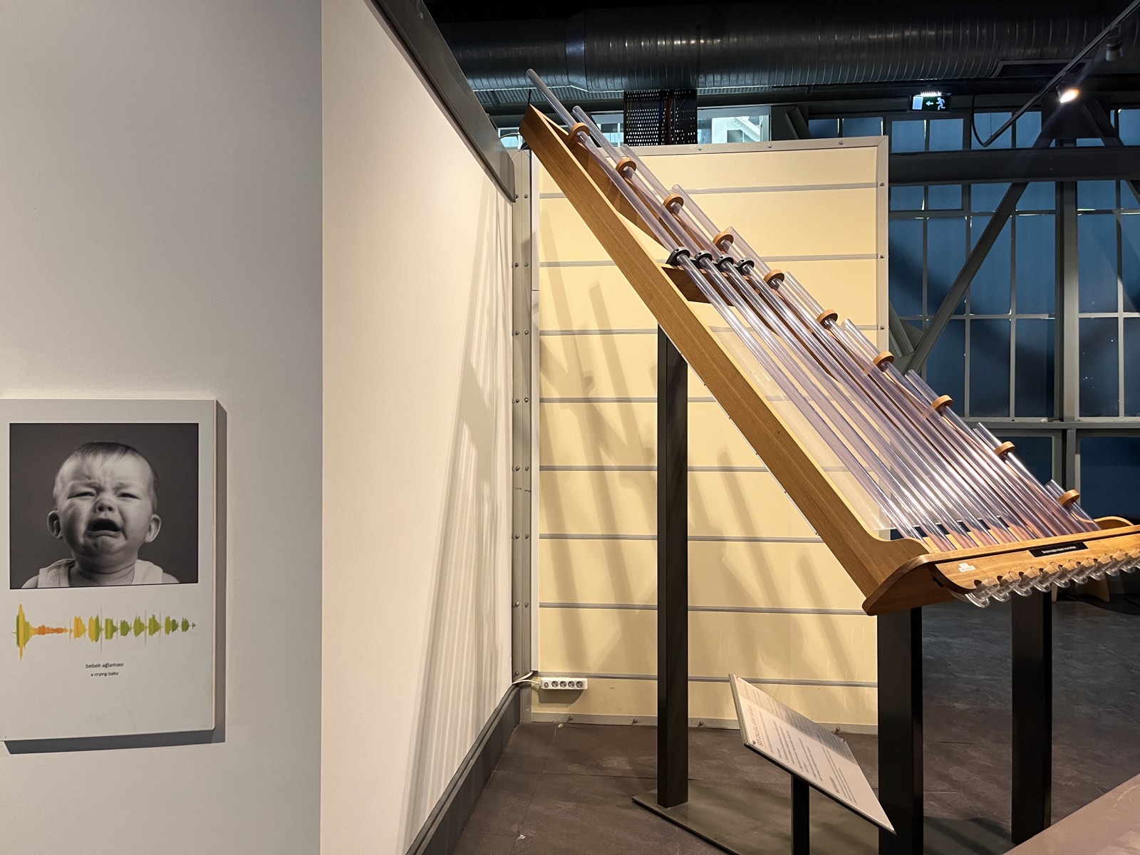 Interactive sound and acoustics exhibit with a tuned tube instrument